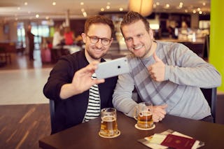 Two men making a selfie while drinking bear