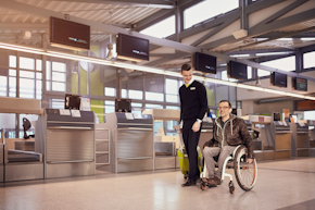 wheelchair user is accompanied by staff