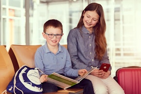 kids reading a book at the gate