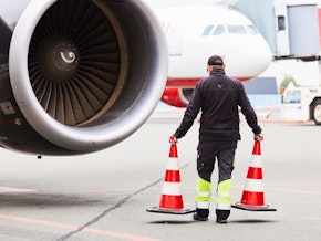 airport staff working on a plane